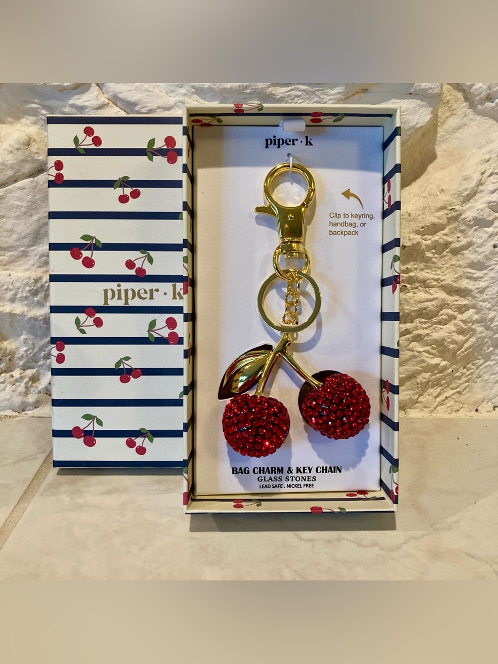 NWT and box Piper K bag charm features a striking cherry bag charm